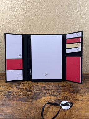 CHANEL notebook with sticky notes and pencil and band.